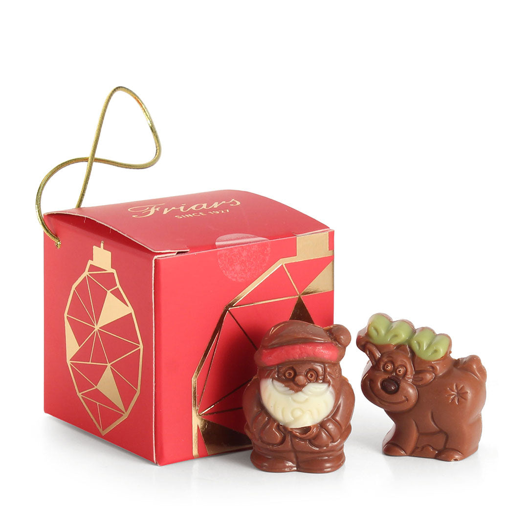 Chocolate Santa and reindeer figures with a red box on a white background